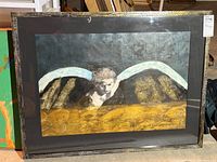 Framed mixed media artwork titled 'Angel over Golden Water' featuring an angel with large wings over a golden textured area, photographed from different angles with some glare on the glass.