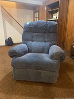 Front view of blue La-Z-Boy reclining armchair, showing plush cushioned seat and padded armrests.