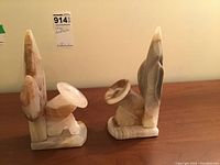 Photo showing two onyx bookends placed standing on a wooden surface, highlighting their size and shape.