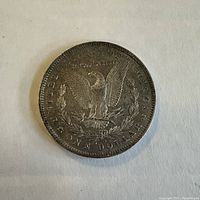 Reverse side of the coin displaying the eagle with spread wings, 'UNITED STATES OF AMERICA,' 'ONE DOLLAR,' and 'IN GOD WE TRUST' inscriptions.