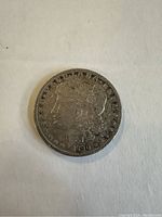 Obverse side of the 1890 O Morgan silver dollar coin showing Lady Liberty with date 1890.