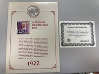 Certificate featuring Alexander Graham Bell's image, biography and death date of 1922 along with the 1922 Liberty dollar coin imprinted.