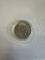 Obverse side of the 1926 Peace Silver Dollar displaying Lady Liberty and date in a protective plastic round case.