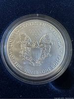 Close-up of 2017 American Eagle silver coin reverse side showing heraldic eagle, inscription, and mint mark 'W'.
