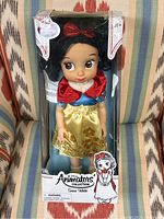 Snow White doll inside original clear plastic display box, showing front view of doll and packaging.