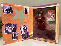 Open box showing Barbie doll and classic film images on the inside flap