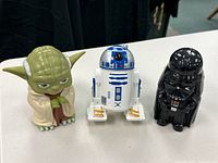 Front view of Yoda, R2-D2, and Darth Vader plastic figures