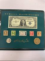 Full view of the framed currency, stamps, and coins collection with George Washington theme
