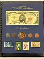 Full set displayed on a blue board with an inscription noting 1909-1999, featuring a 1963 $5 bill, five coins, and four stamps.