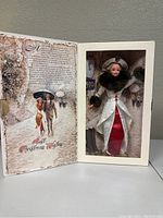 Barbie doll in original box with holiday themed background and greeting on inside flap