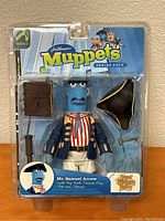 Front view of Mr. Samuel Arrow action figure in blister pack with accessories and packaging details.