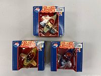 Front view of all three Pepsi aeroplane models in their retail boxes arranged facing forward