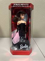 Front view of Solo in the Spotlight Barbie doll in original red and clear display case, showing doll in black glittery gown with pink wrap.