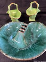 Photo showing the Blue Mountain Pottery ashtray with its green variegated glaze and three cigarette rests, alongside the two matching Royal Winston green ceramic pieces with gold trim and handles.