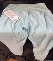 Front view of light blue Lululemon leggings size 10 with brand tag visible.