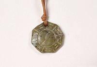 Top view of the octagonal carved pendant showing the full design and color variations.