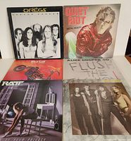 Photo showing all six vinyl LP album covers arranged in two rows, including Dregs, Quiet Riot, Mötley Crüe, Alice Cooper, Ratt, and Dokken albums.