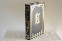 Front cover of the book showing black leather with gold embossed borders and a central rectangular ornament with Chinese characters, presenting an elegant design typical of Franklin Library editions.