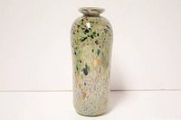 Front and side views of the tall iridescent splatter art glass vase with swirled multicolor patterns.