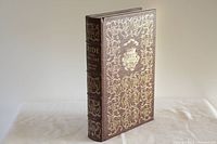 Front cover of the leather-bound book showing intricate gilt designs including a ship motif conforming to Easton Press collector editions