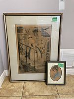 Full view of two framed artworks: larger Louis Icart Milkmaid print and smaller oval portrait of a young lady, both matted and glass framed.