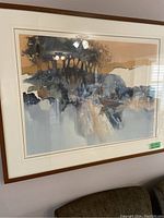 Framed watercolor print with abstract landscape and boat scene.