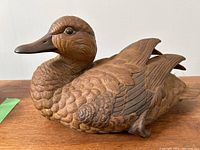 Side front view of the stoneware mallard, showing detailed feather texture and natural brown coloring.