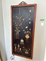 Full front view of framed panel showing marble inlay design and carved top crest