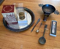 Full overview showing the tray, all utensils, the small cup, two boxed items including the Peter Henlein drum watch and souvenir spoon.