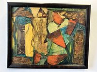 Front view of the framed mixed media collage showing abstract shapes in earth tones with visible textures and layering.