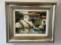 Front view showing the framed oil painting of a villa dock scene, signed by Simon