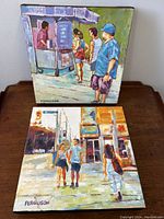 Two canvases stacked vertically on a tabletop showing both paintings front view