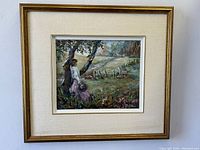 Framed oil painting showing woman in countryside landscape signed by Merle Proctor.