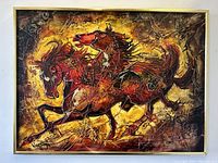Full front-facing photo of the framed painting showing two wild mustang horses in dynamic motion with rich colors and texture.