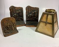 Photo showing two matching Wise Old Owl cast metal bookends, one single cast bookend, and slag glass light fixture together on white background.