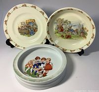 Three children's dishes: Royal Doulton Bunnykins 8 inch plate, 7.5 inch Bunnykins bowl, and unmarked 7.75 inch baby bowl with children illustration
