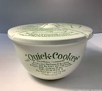 Side view of the white ceramic bowl with the printed green text advertising the Grimwades Quick Cooker and patent information.