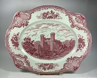 Full view of the Johnson Brothers Old Britain Castle Series platter, showing scalloped edges and floral border detailed in pink transferware.