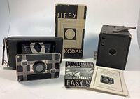 Both cameras, the No. 2 Brownie and Jiffy Kodak Six-20 with original box and two pamphlets shown together