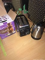Photo of all three appliances: T-Fal Avante toaster, Chefman electric kettle, and boxed Cadbury chocolate fountain.