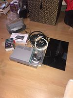 Overview photo showing Sony FVD/VHS player, Radio Shack TCR-200 box, telephone cassette recorder, HDMI cord, wiring and TV stand.