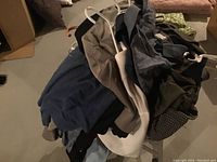 Golf shirts piled on plastic hangers showing multiple colors and types