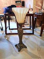 Front angle showing the full lamp with metal base and ribbed glass shade