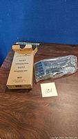 Photo of Pampered Chef Quick Shred kitchen shredder with original box and shredder tool still in plastic wrap on a wooden surface