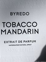 Close-up of front label showing brand, fragrance name, concentration, and volume