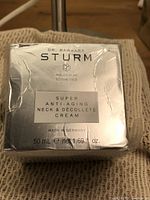 Front view of the silver box with product name, brand, quantity, and origin.