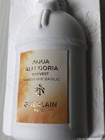 Front view of sealed bottle in foam packaging showing gold label.
