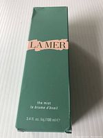Front of the sealed green La Mer The Mist box showing branding, product name, and volume (100ml).