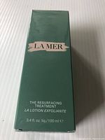 Front view of green box packaging labeled La Mer The Resurfacing Treatment 3.4 fl. oz.