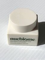 White square jar with white lid, Nuebiome brand and product name visible on front face.